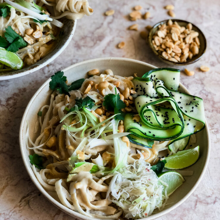 IMG_7277-2 Satay noodles with ribbons of courgette, roasted peanuts, lime and sauerkraut and black sesame seeds with a bowl of peanuts in the background