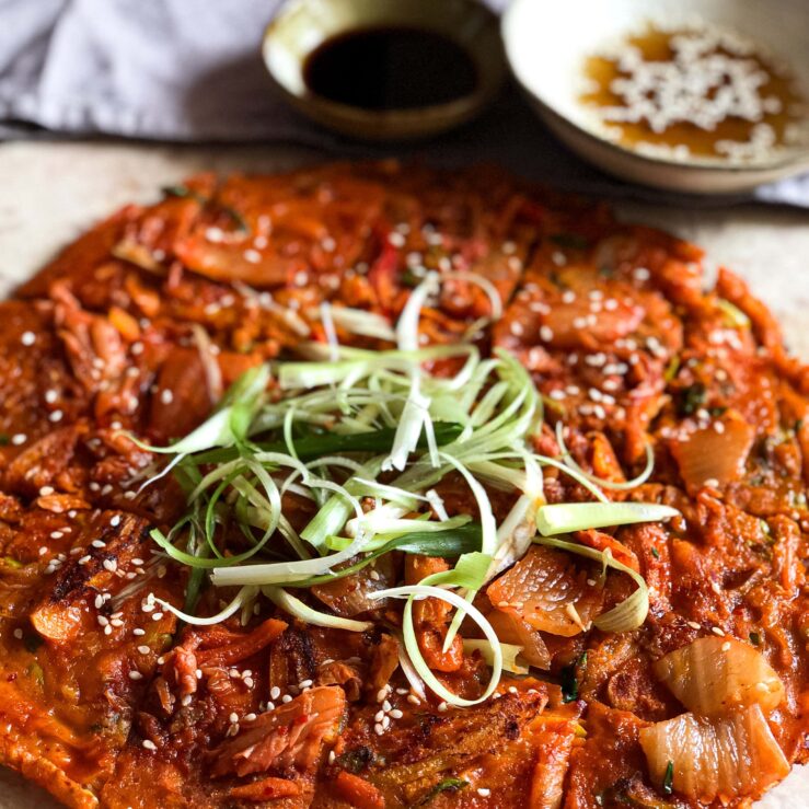 IMG_7501-3 Kimchi pancake with spring onion shavings and soy sauce dip in the background