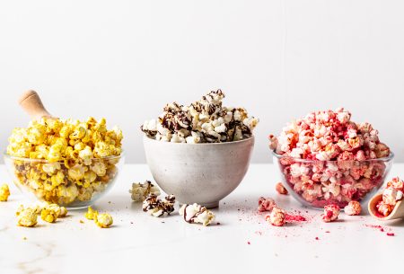 View Popcorn 3 ways Three bowls of popcorn with the three different toppings on each