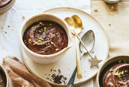 View Pistachio & chocolate pots One pistachio and chocolate pot served in a bowl. topped with pistachios and displayed on an additional plate