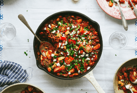 View Gut-loving Greek baked beans Gut-friendly Greek baked beans in a pan on a white table