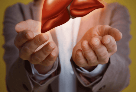 View Gut-Liver Axis in NAFLD Two hands outstretched holding up an animated image of a liver
