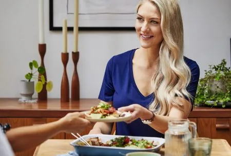 View Can food really boost our mood? The ‘SMILES’ trial Megan Rossi around the dinner table sharing food with others