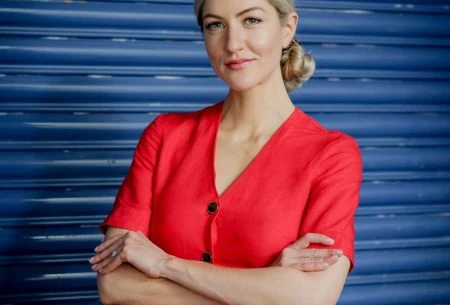 View The ugly side of the #guthealth trend… Megan Rossi, folded arms in a red dress