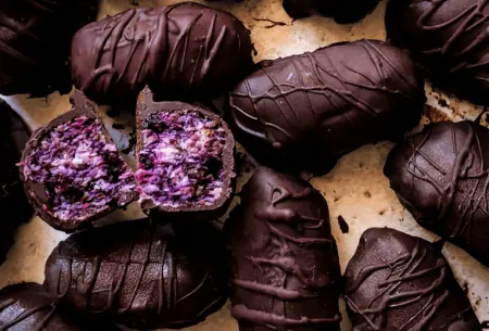 View Bounty bar bites Photo of bitesize bounty bars that also include blueberries and beetroot, on a kitchen counter top