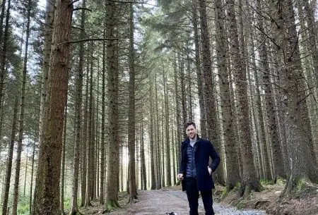 View Heard of forest bathing? Man and dog in forest