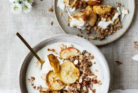 View Powerful polyphenols A bowl of yogurt with granola and dried apple and another plate with dried apple and granola and a sprinkle of yogurt