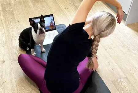 View Exercise during Covid-19 Megan Rossi on a yoga mat with laptop and dog