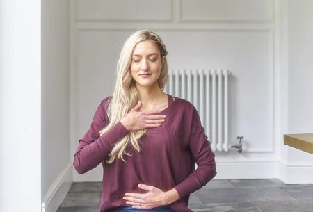 View 5 ways to look after your mental health (& gut health!) Dr Megan Rossi sitting cross-legged on the ground in a mindful yoga pose