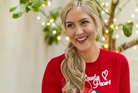 View Christmas dinner digested Megan Rossi pulling a cracker with a christmas jumper on