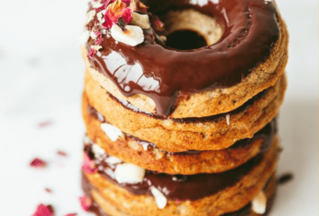 View Super seedy & nutty breakfast donuts A stack of chocolate breakfast donuts sprinkled with rose petals and hazelnuts