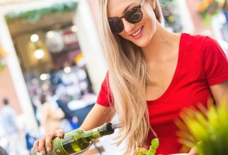 View Extra virgin olive oil: why it’s the winning oil Megan Rossi at a table drizzling olive oil onto the salad