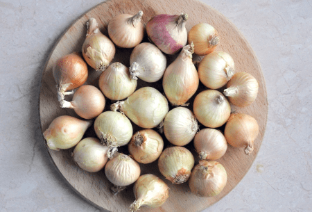 View The low-down on the low-FODMAP diet A wooden plate full of onions