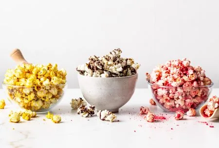 View Popcorn 3 ways Three bowls of popcorn with the three different toppings on each