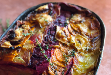 View Root vegetable gratin with white bean bechamel Photo of a root vegetable gratin on a kitchen worktop