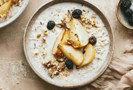 View 4 reasons to enjoy wholegrains every day Full bowl of porridge on benchtop with fresh fruits and seeds scattered on top