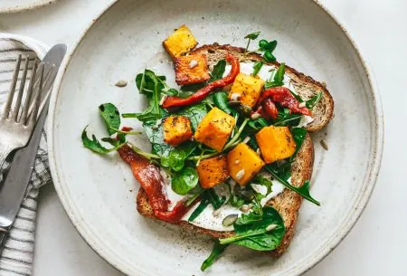 View Butternut squash & feta open sandwich One piece of bread shown as an open sandwich with butternut squash, feta and fresh greens