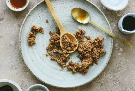 View The science of sweeteners A plate of sugar, with two spoons and small bowls surrounding showing all different types of sugars and sweetners