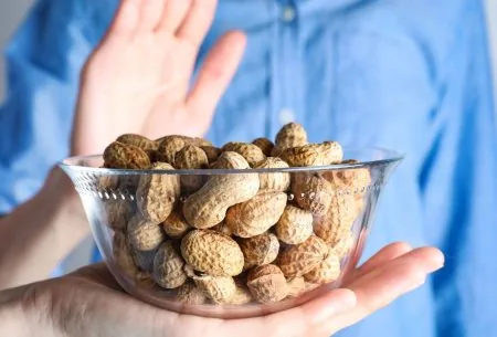 View Experiencing food allergies? Support your health with these simple dietary swaps Woman experiencing food allergies