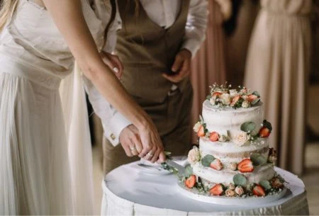View Taking care of your gut while planning your wedding A couple cutting a wedding cake together