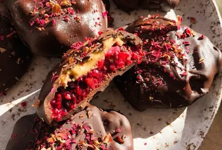 View Jammy love bites An image of the berry jam & nut butter chocolate bites on a plate