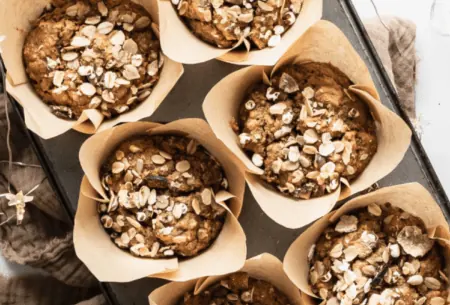 View No added sugar gingerbread muffins Six freshly baked gingerbread muffins in a muffin tray, sprinkled with granola