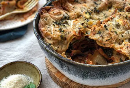 View Veggie packed lasagne Large serving dish on bench filled with fresh cooked lasagne, one piece cut away to show inside