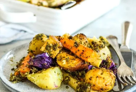 View How to have a gut-loving Christmas A plate with roasted potatoes, parsnips and walnut pesto